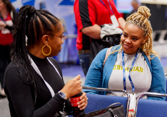 Photo of two women talking at LibLearnX 2023