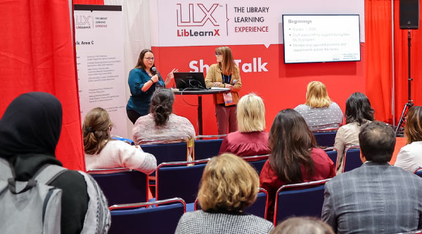 ShopTalk photo of speakers presenting to a seated audience